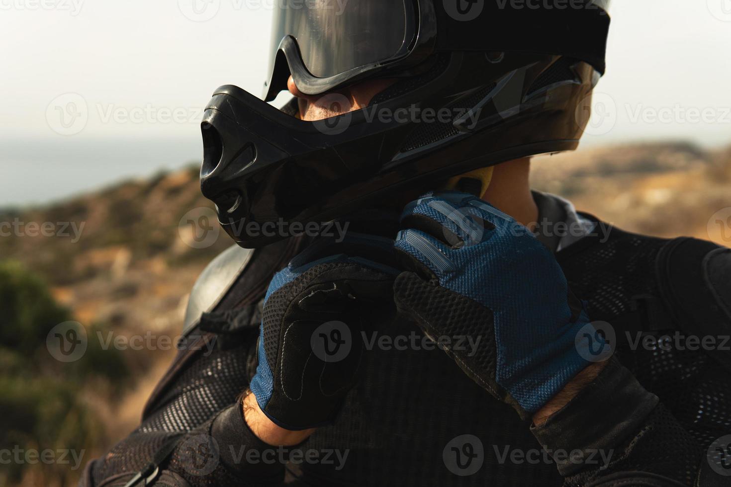 MTB rider is wearing helmet for protection during downhill ride photo