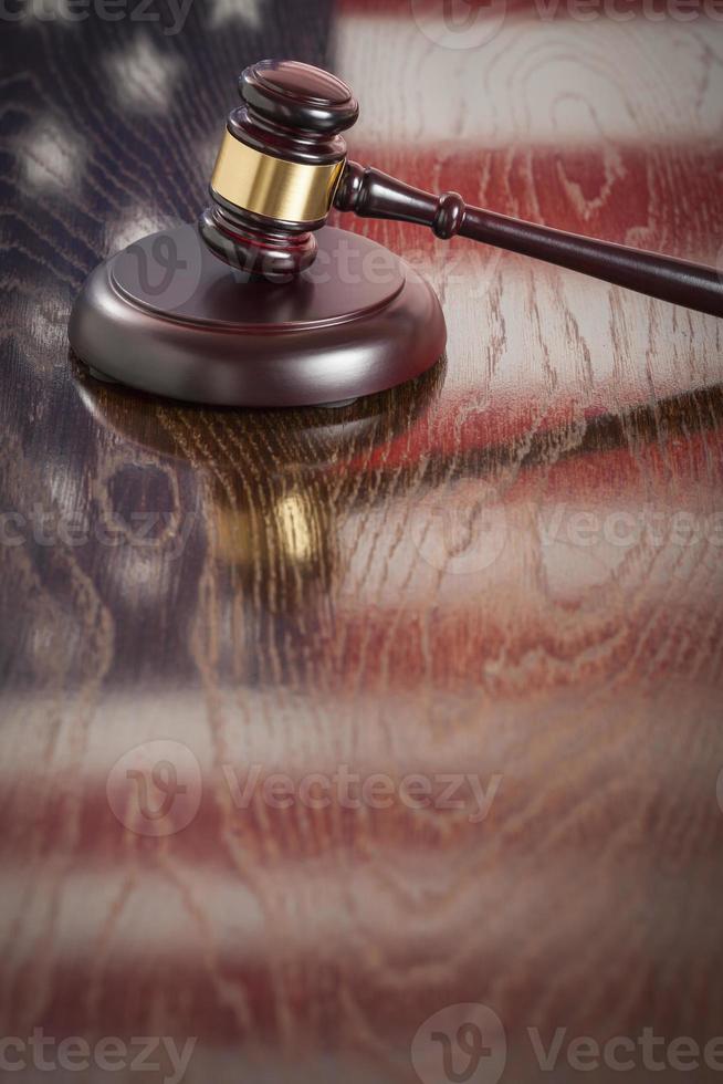 Wooden Gavel Resting on Flag Reflecting Table photo