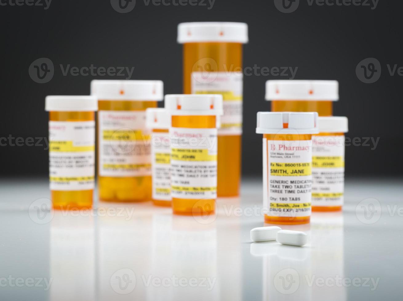 Medicine Bottles and Pills on Reflective Surface With Grey Background photo