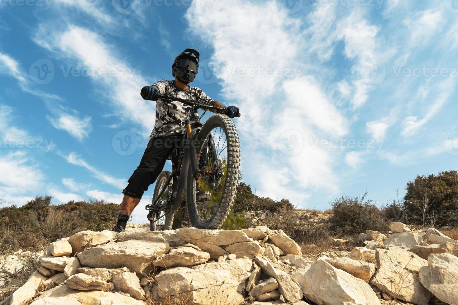 Professional bike rider during downhill ride on his bicycle photo