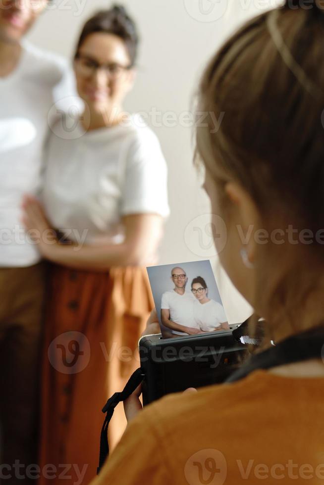 Girl made a photo of her parents using instant camera