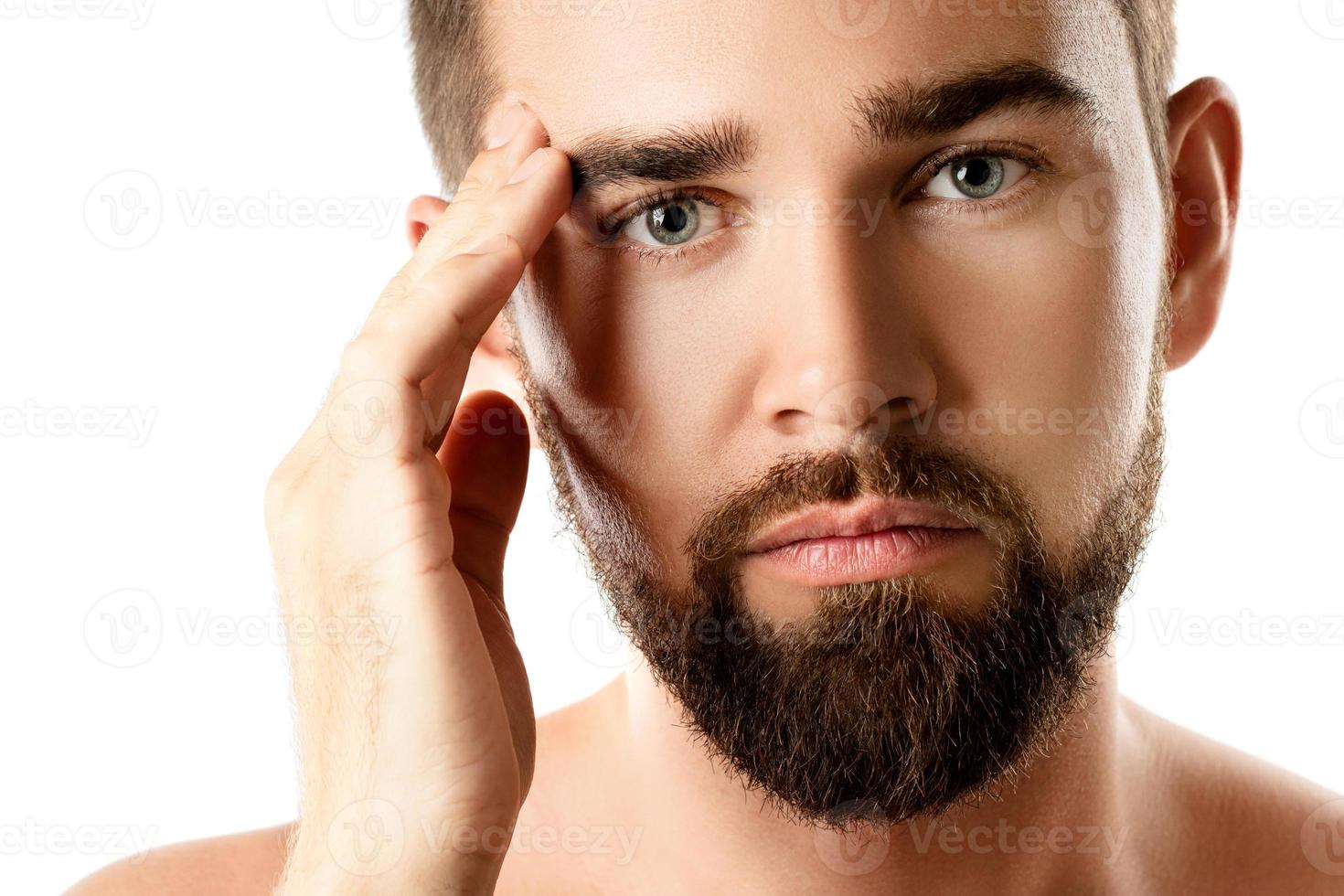 Young and handsome bearded man with smooth skin photo