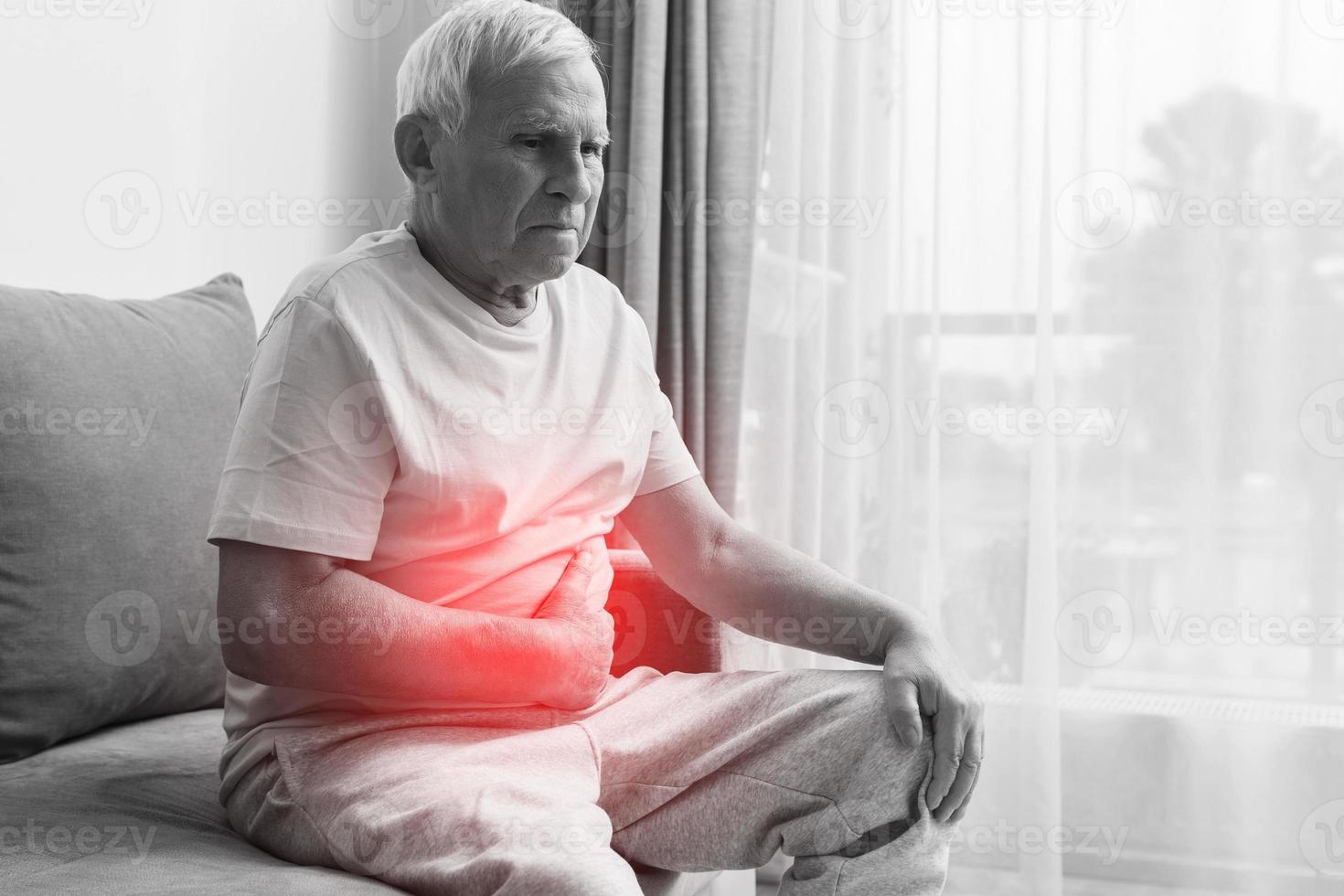 Senior man is suffering from problems with a digestion photo