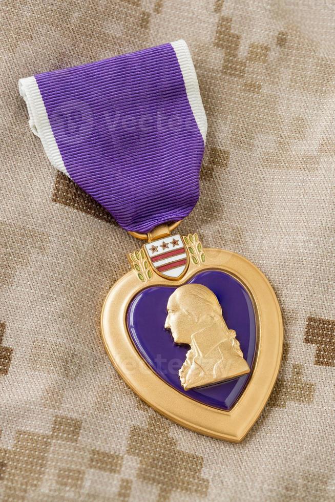 Purple Heart Medal Laying on Military Fatigues photo