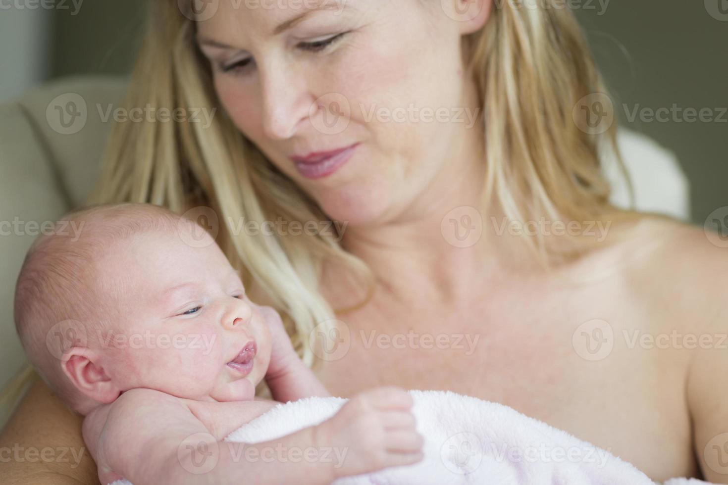 Young Beautiful Mother Holding Her Precious Newborn Baby Girl photo