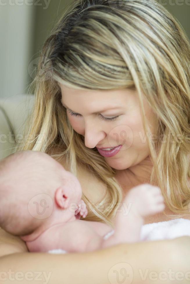 Young Beautiful Mother Holding Her Precious Newborn Baby Girl photo