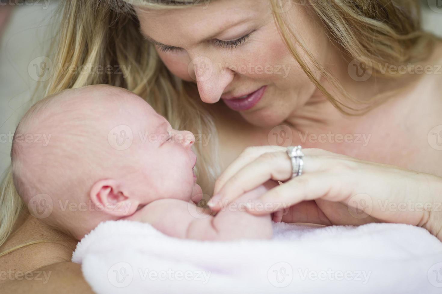 Young Beautiful Mother Holding Her Precious Newborn Baby Girl photo