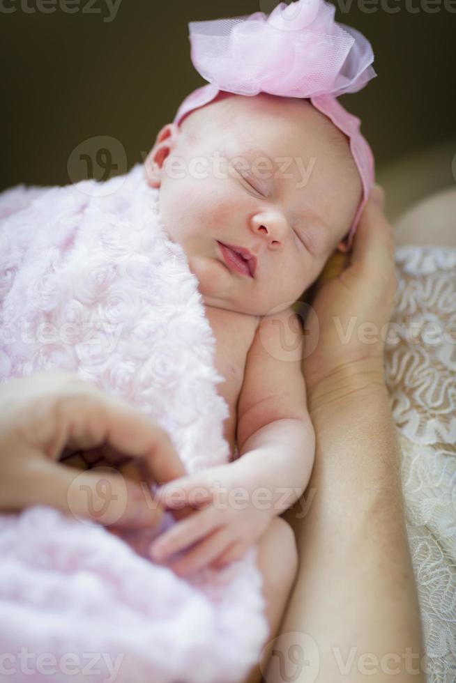 Hands of Mother Holding Her Newborn Baby Girl photo