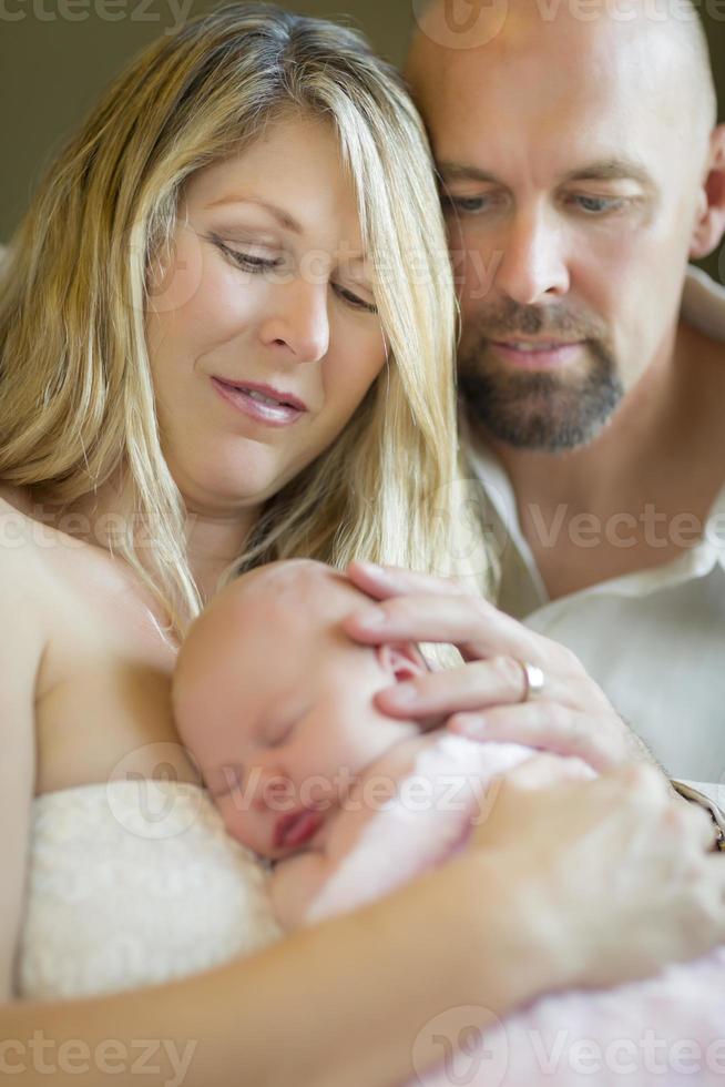 Beautiful Young Couple Holding Their Newborn Baby Girl photo