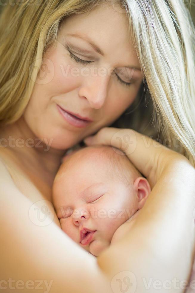 Young Beautiful Mother Holding Her Precious Newborn Baby Girl photo