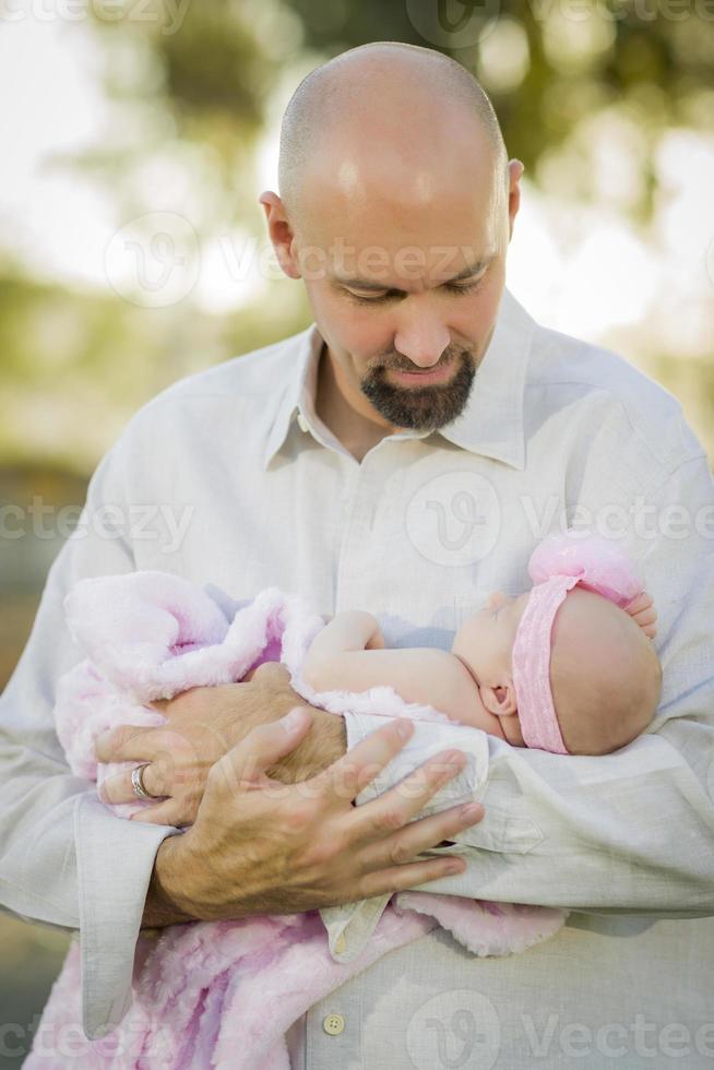 Young Handsome Father Holds His Newborn Baby Girl photo