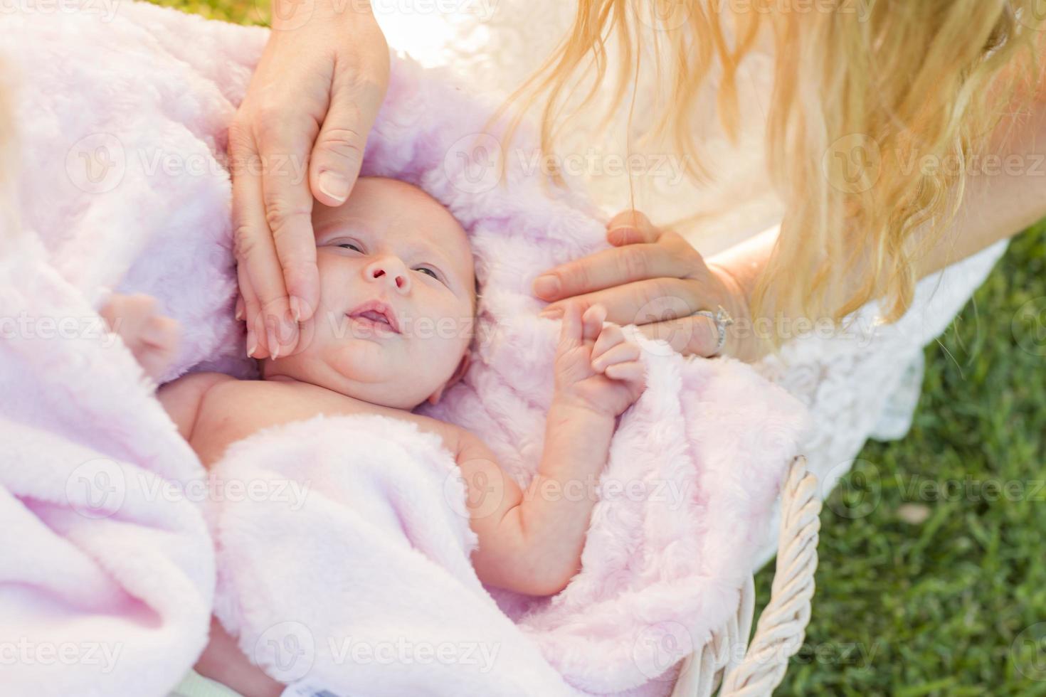 Hands of Mother Caressing Her Newborn Baby Girl photo