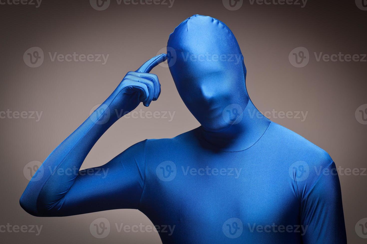 Man Wearing Full Blue Nylon Bodysuite Scratching Head photo