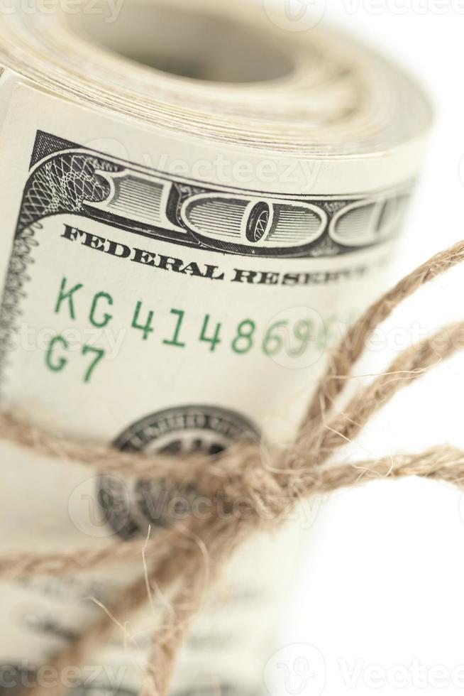 Roll of One Hundred Dollar Bills Tied in Burlap String on White photo