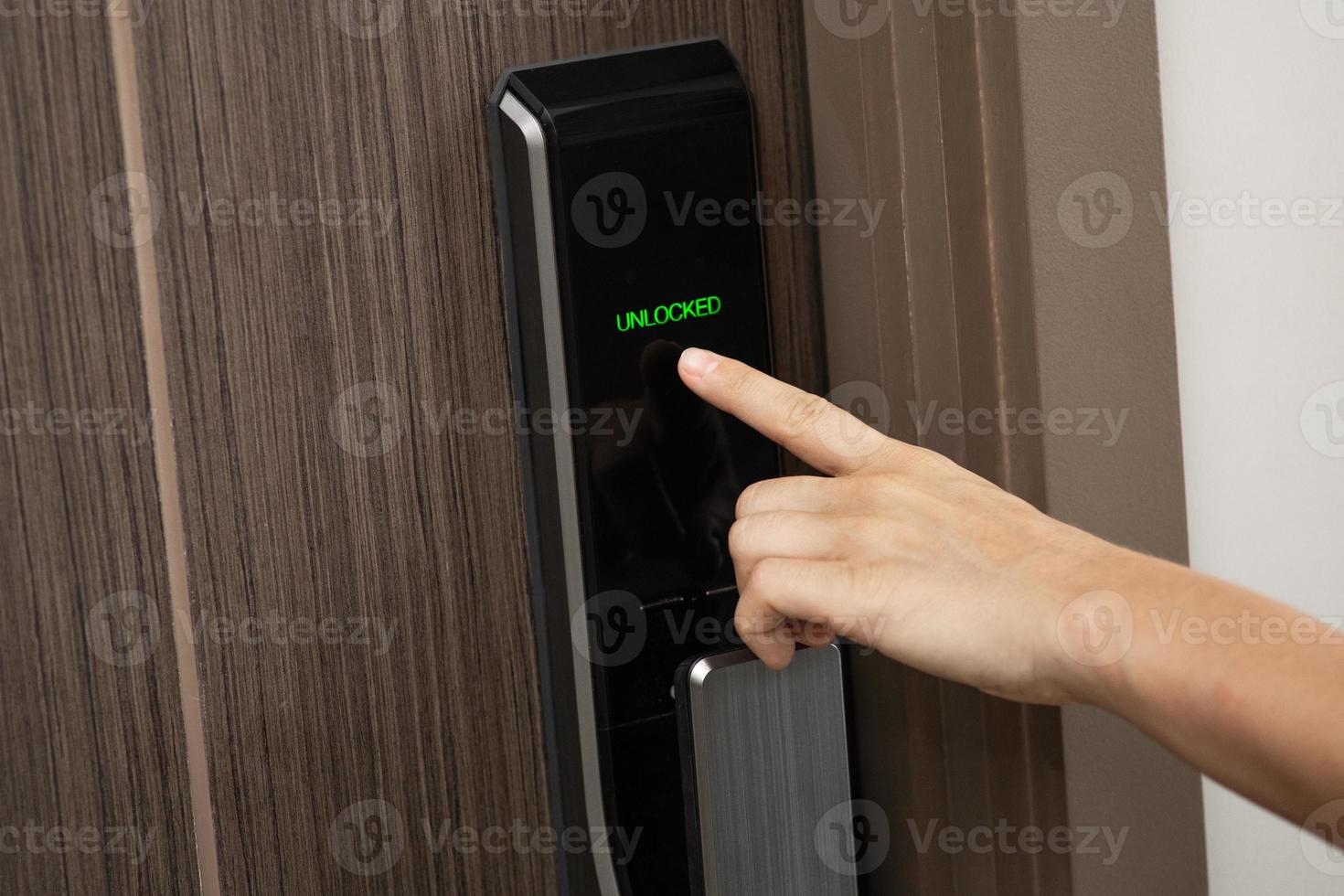 Hand and digital smart code lock into the modern apartment photo