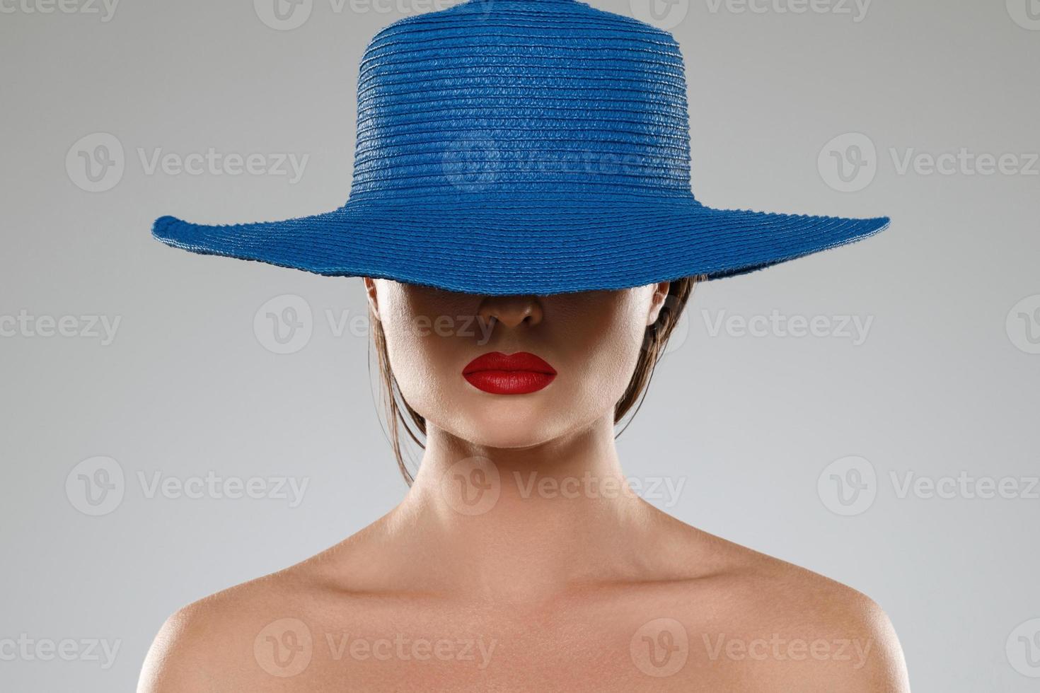 Portrait of stranger girl with red lips wearing blue hat photo