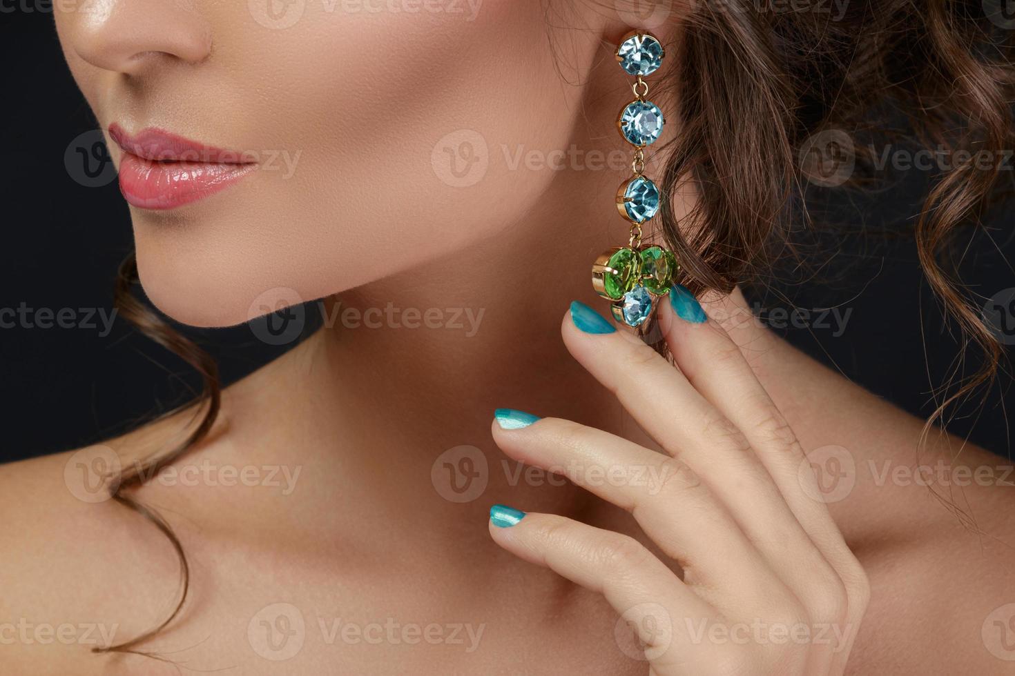 Woman is wearing beautiful and expensive earrings photo