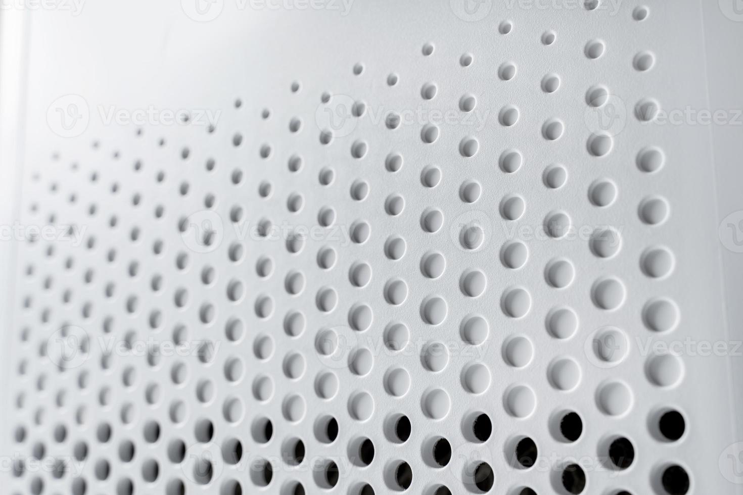Abstract background hi-tech plastic surface with a holes and circles photo
