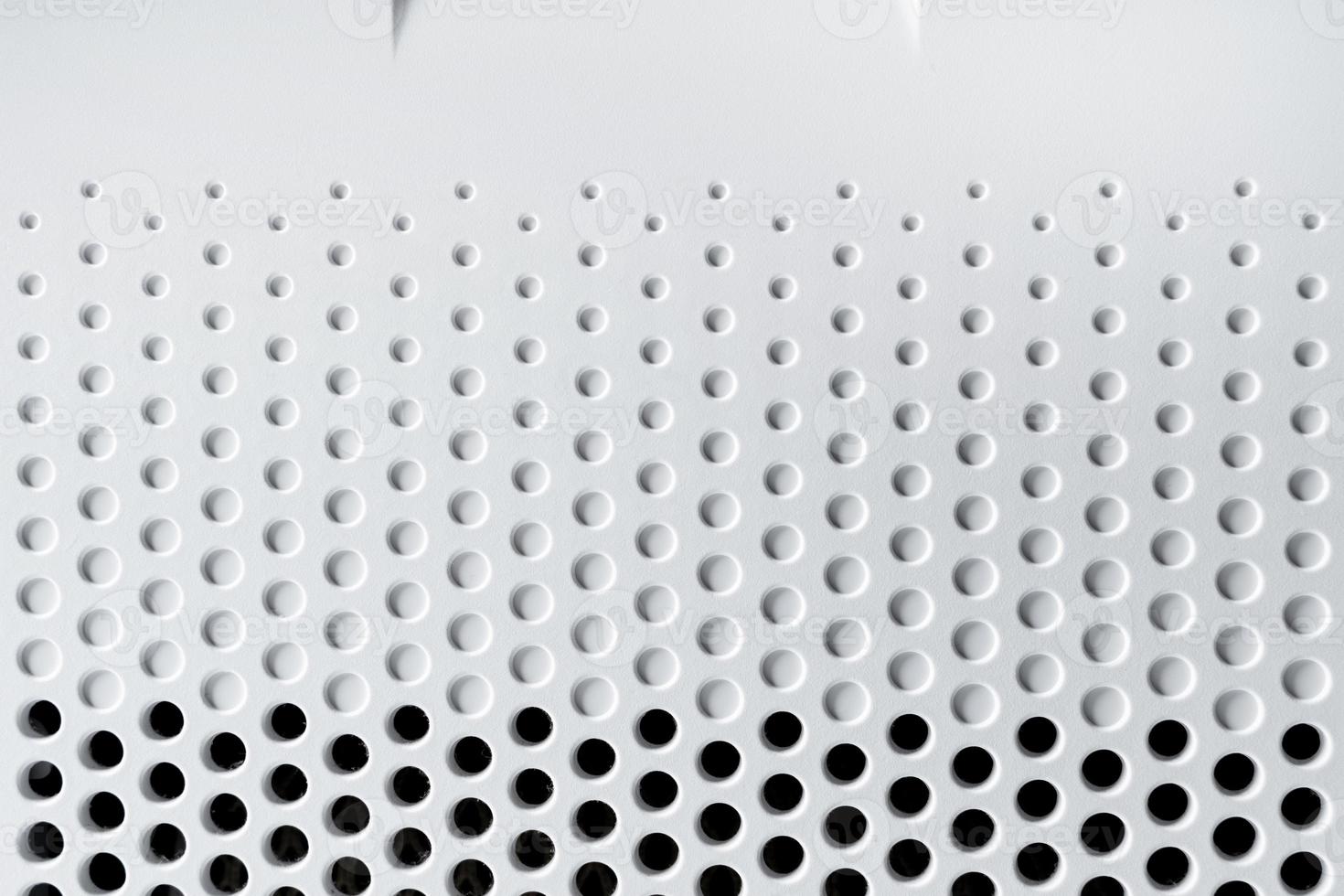 Abstract background hi-tech plastic surface with a holes and circles photo