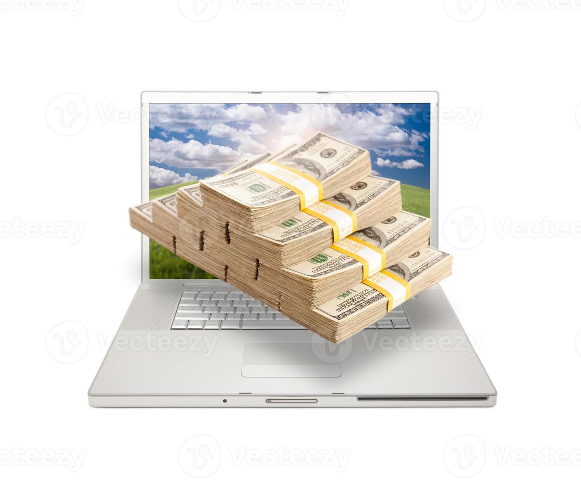 Laptop with Stacks of Money Coming From Screen photo