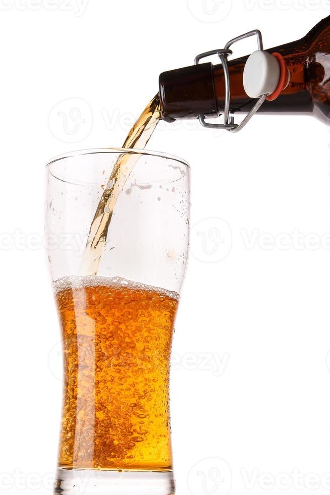 Beer is pouring into a glass photo