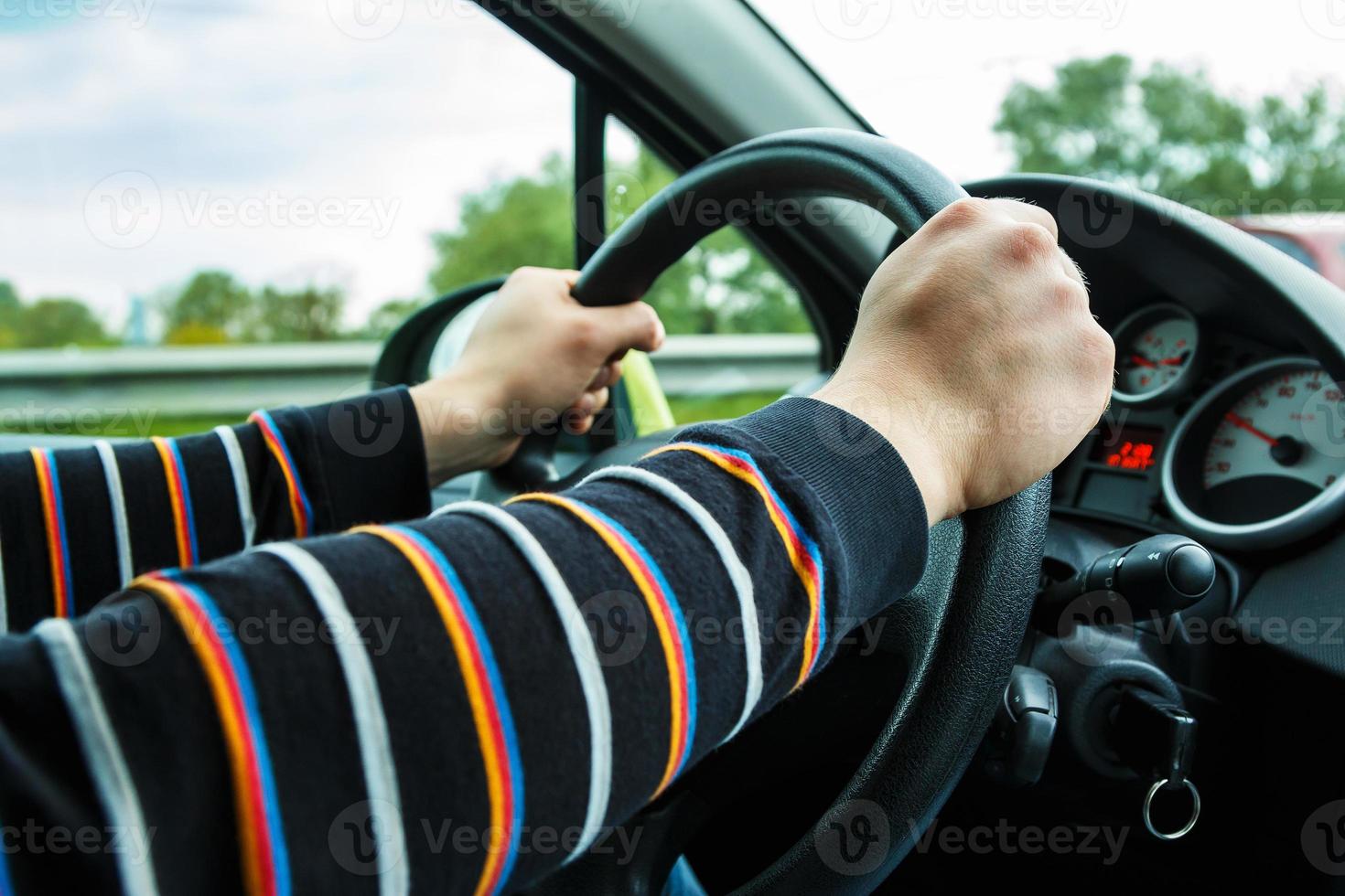 Male hands on steering wheel photo