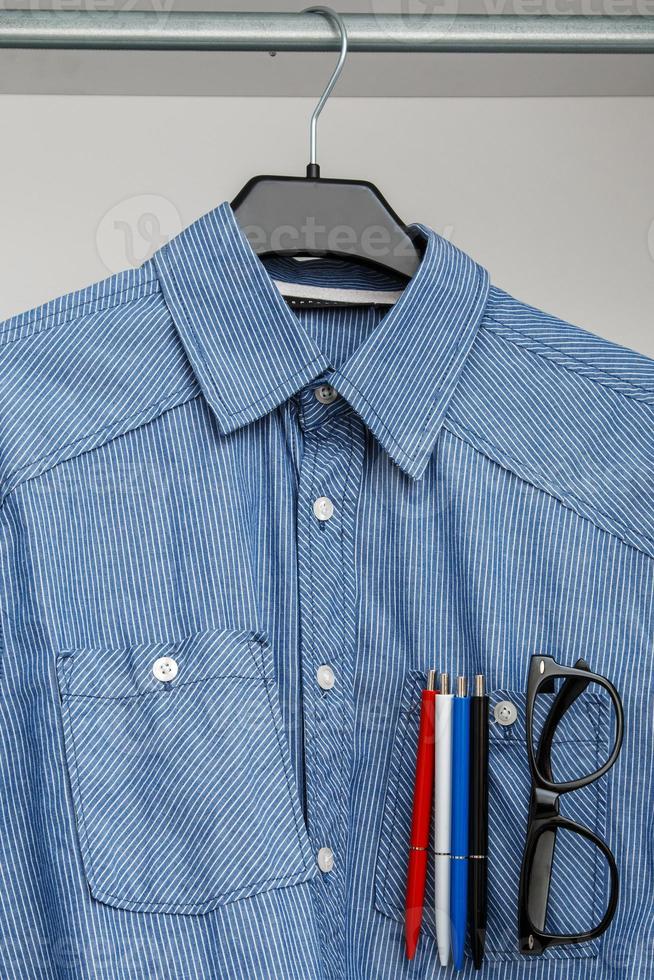 Shirt with colorful pens and eyeglasses in pocket photo