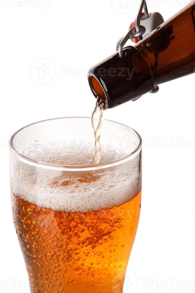 Beer is pouring into a glass photo