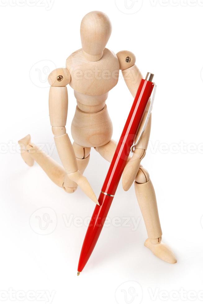 Small wooden dummy and ballpoint pen photo