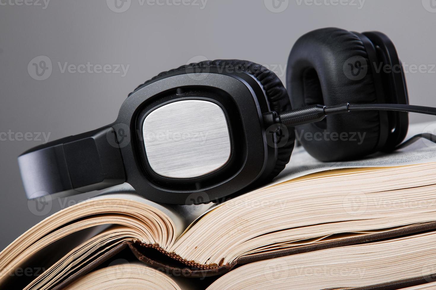 Audiobooks concept with books and headphone photo