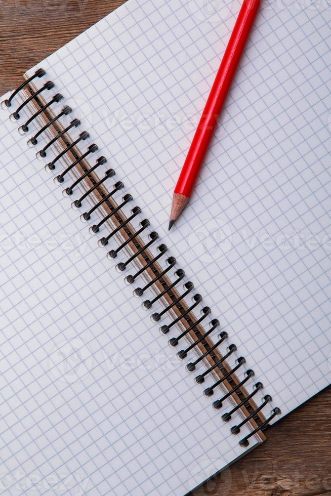 Notepad on wooden surface photo