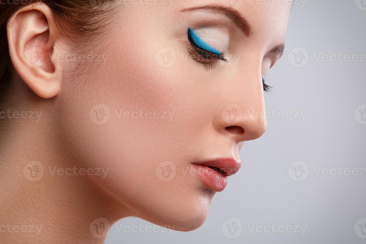 Woman with blue eyeliner on her eyes photo