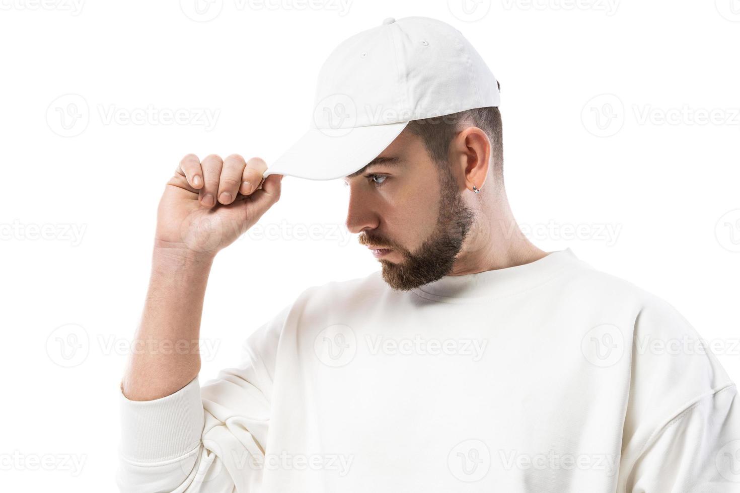 Handsome man wearing blank white cap on white background photo