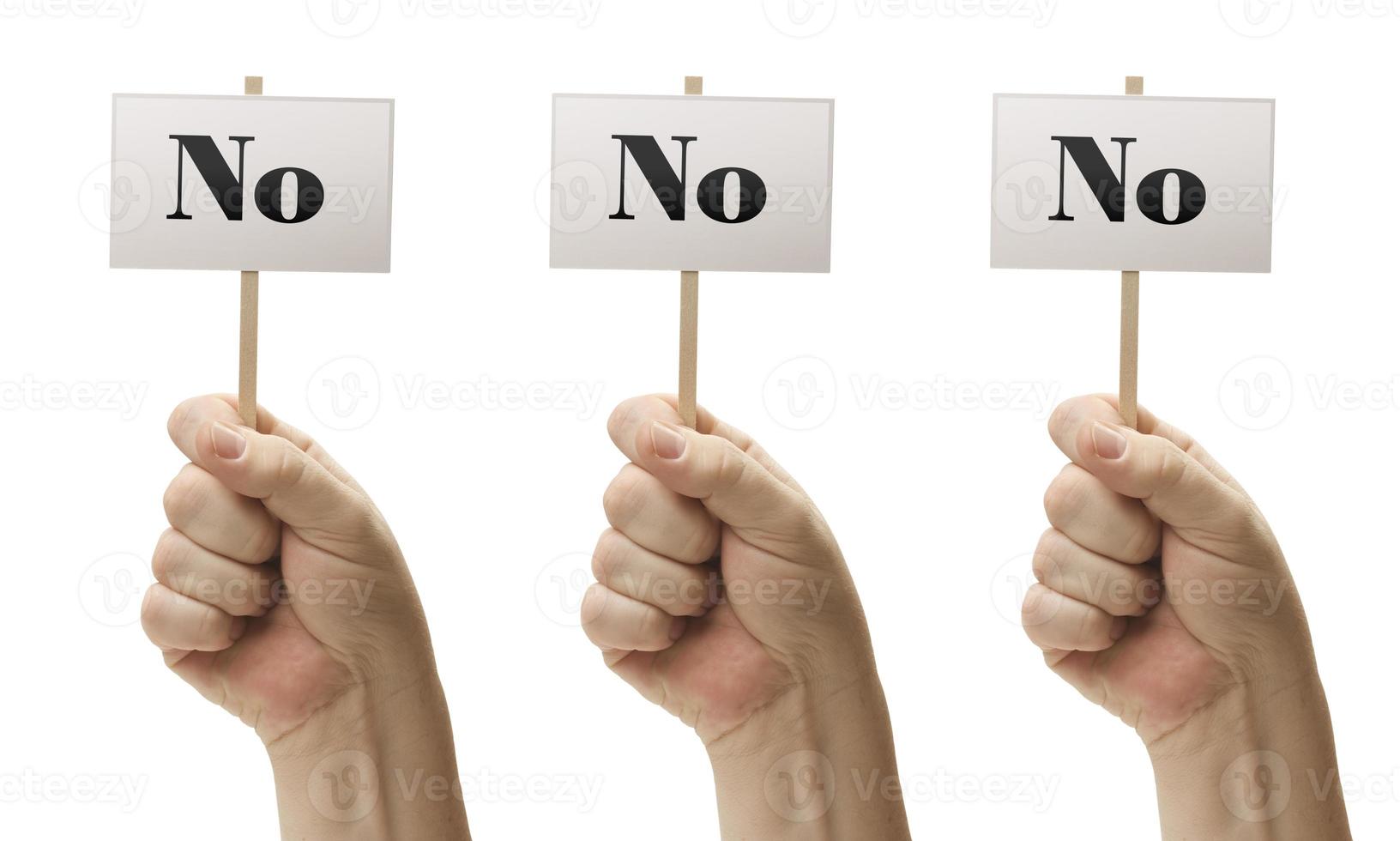 Three Signs In Fists Saying No, No and No photo