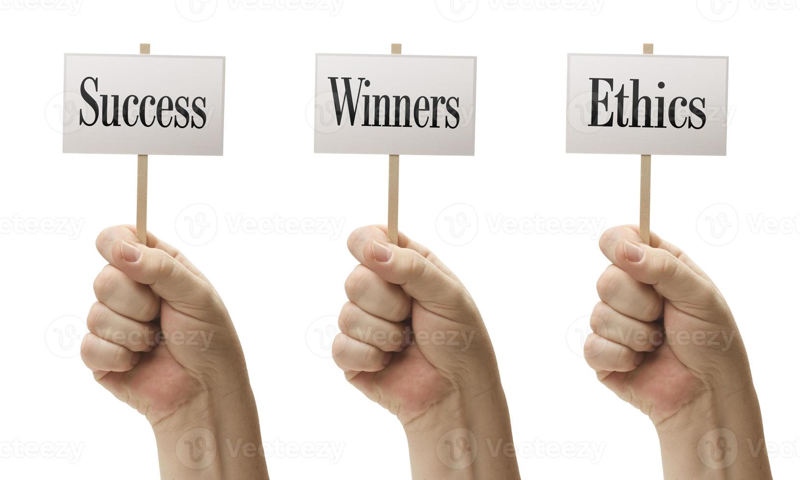 Three Signs In Fists Saying Success, Winners and Ethics photo