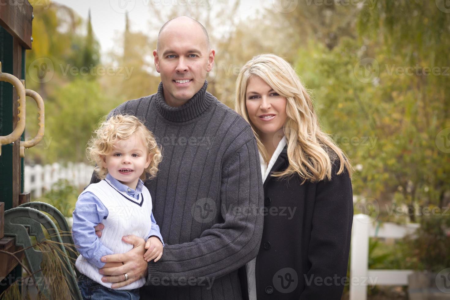 Young Attractive Parents and Child Portrait in Park photo