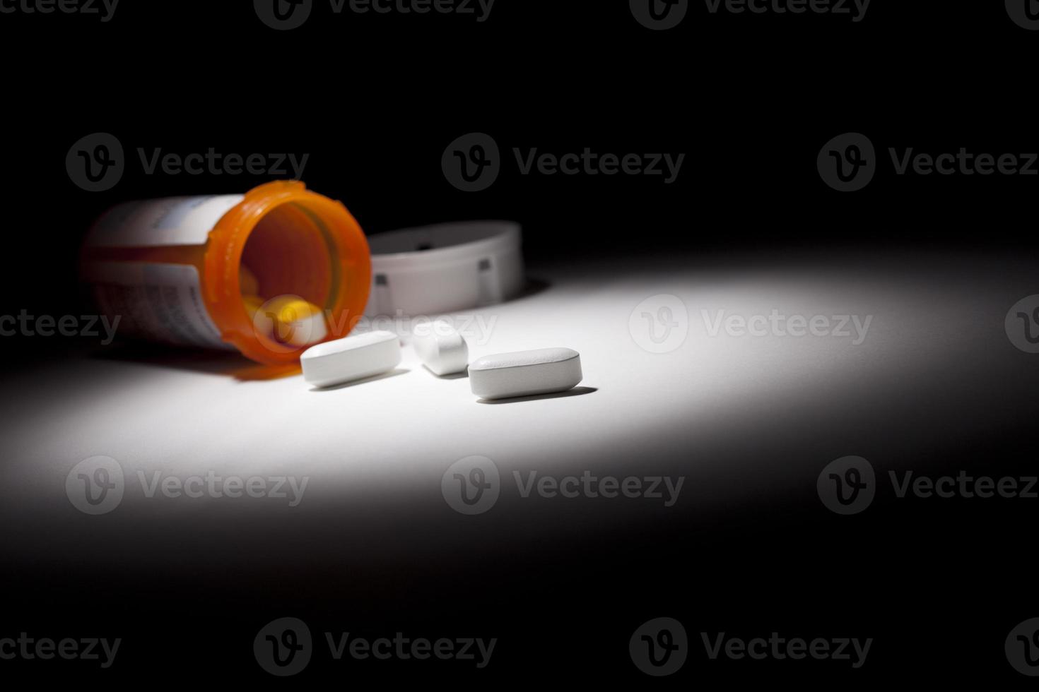 Medicine Bottle and Pills Under Spot Light photo