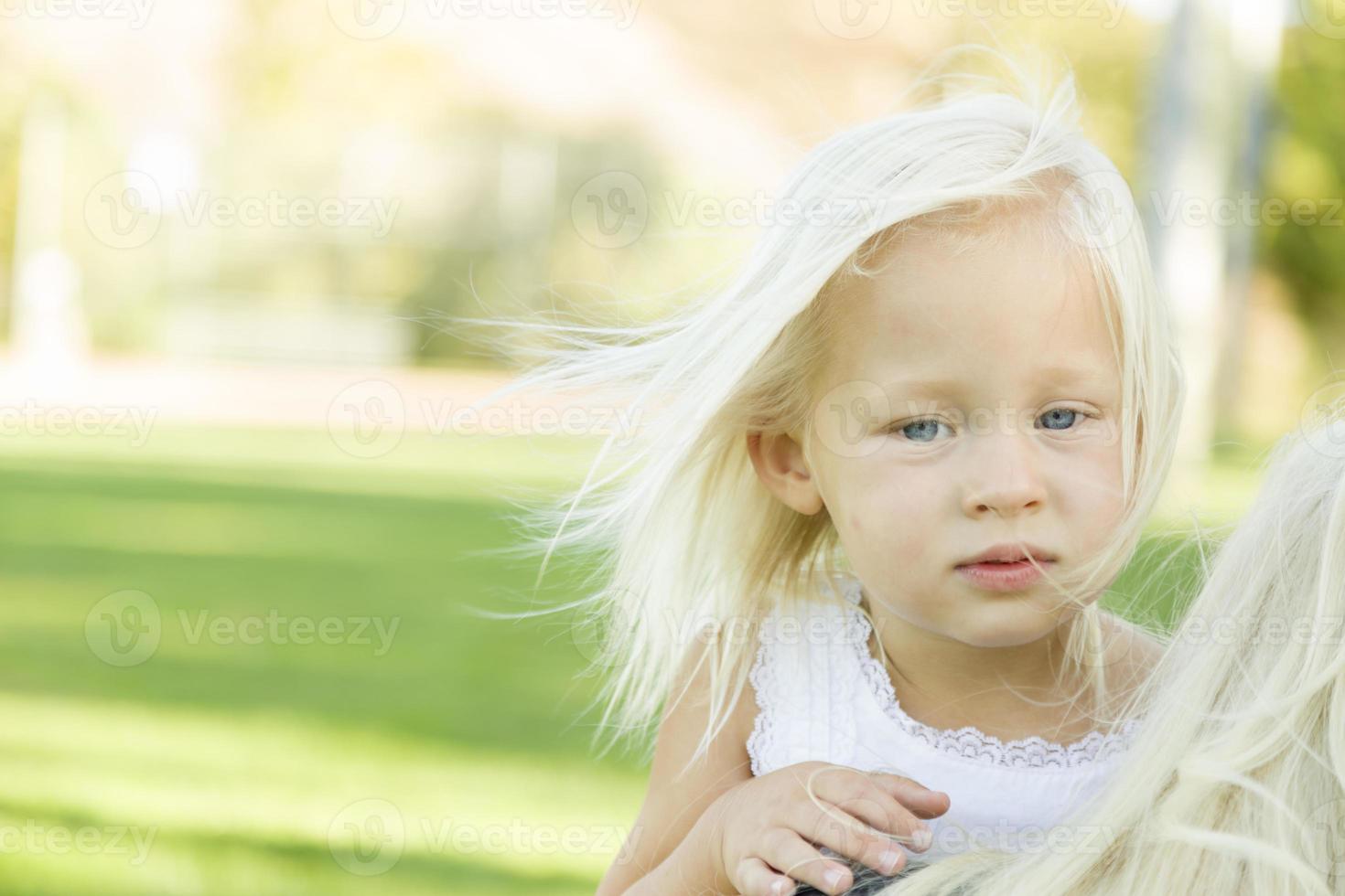 Melancholy Portrait of Cute Little Girl Outside photo