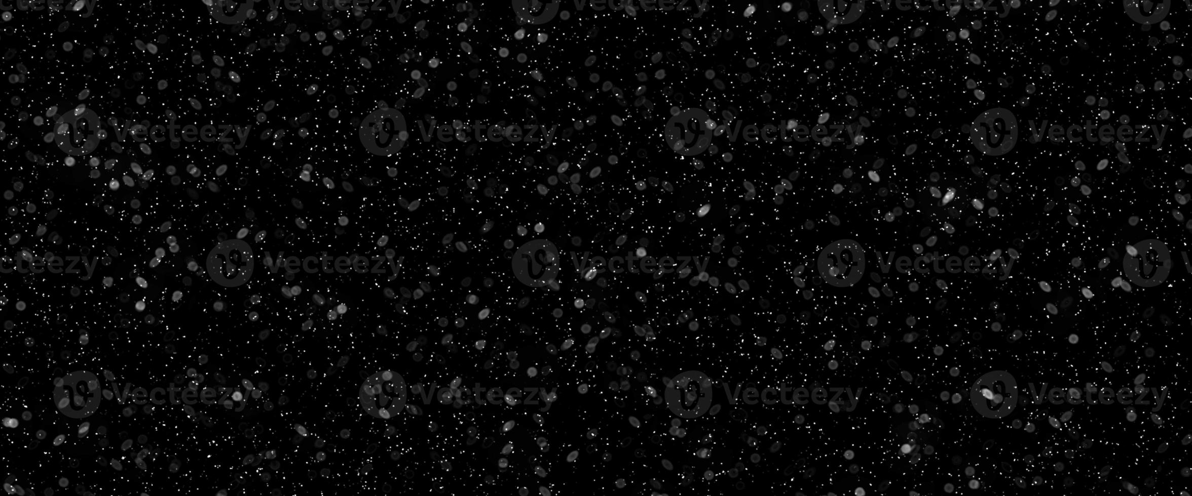 Falling snow isolated on black background. Falling snow at night. Bokeh lights on black background, flying snowflakes in the air. Winter weather. Overlay texture. photo