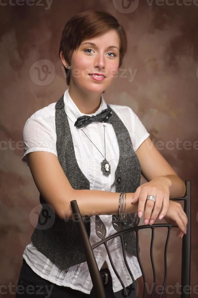 Attractive Red Haired Young Adult Female Portrait Leaning on Chair photo