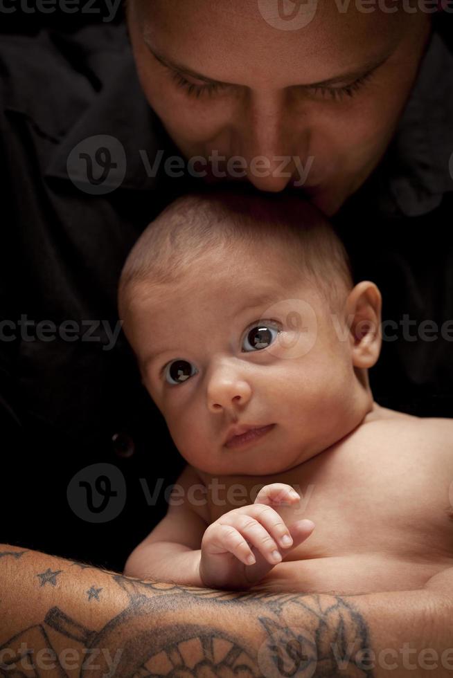 Young Father Holding His Mixed Race Newborn Baby photo