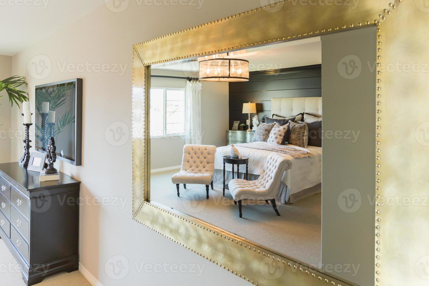 Beautiful Bedroom Reflection in Decorative Mirror. photo