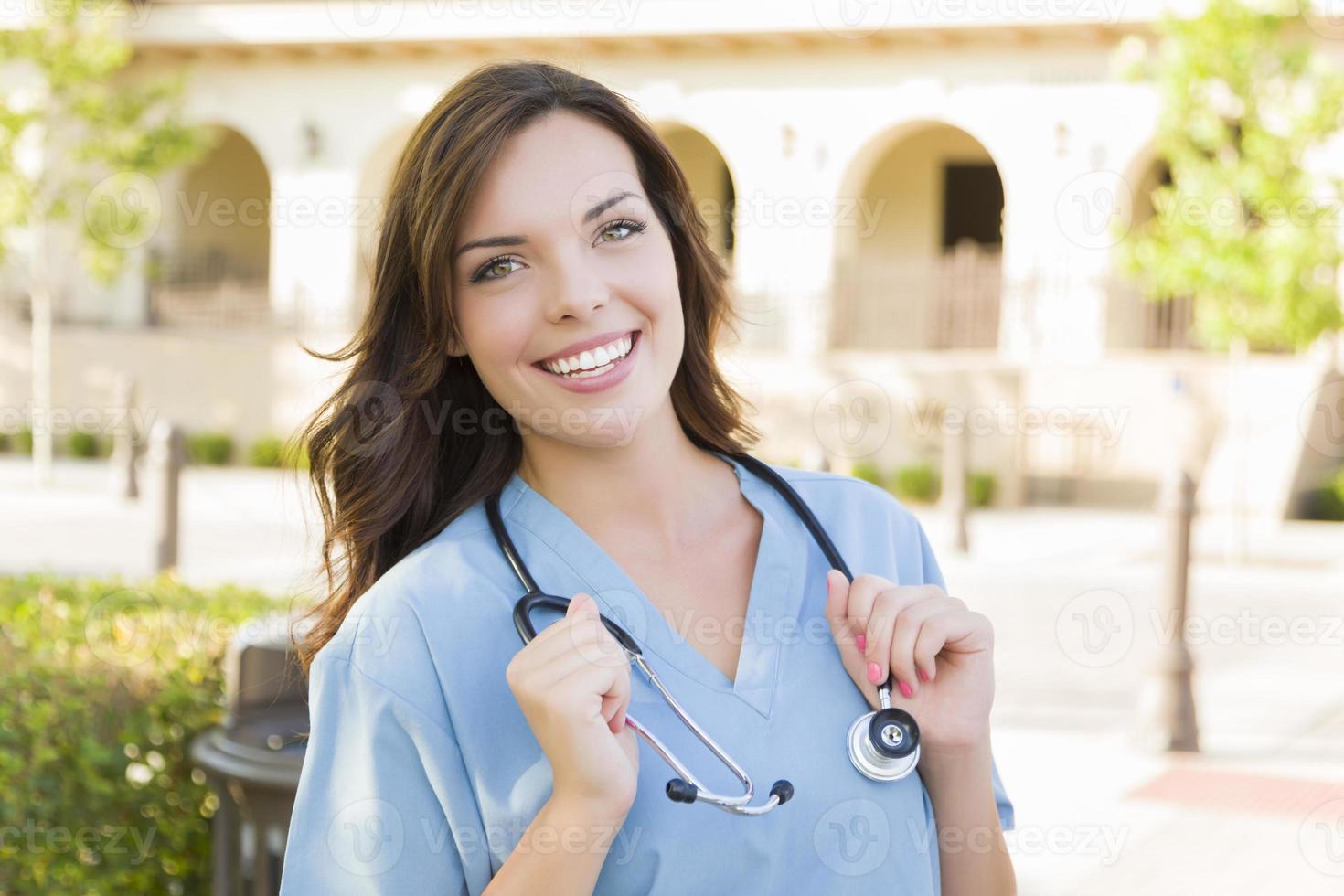 Proud Young Adult Woman Doctor or Nurse Portrait Outside photo