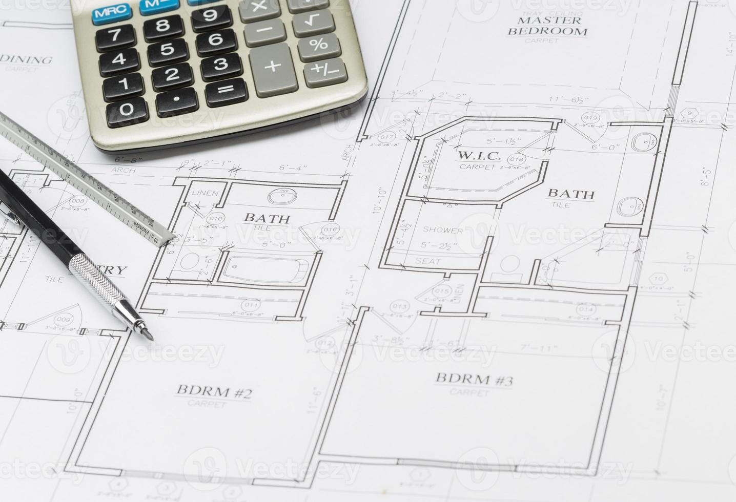 Pencil, Ruler and Calculator Resting on House Plans photo