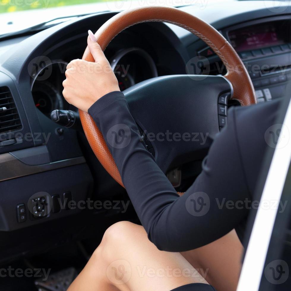 Sexy lady driver sitting in a white car photo