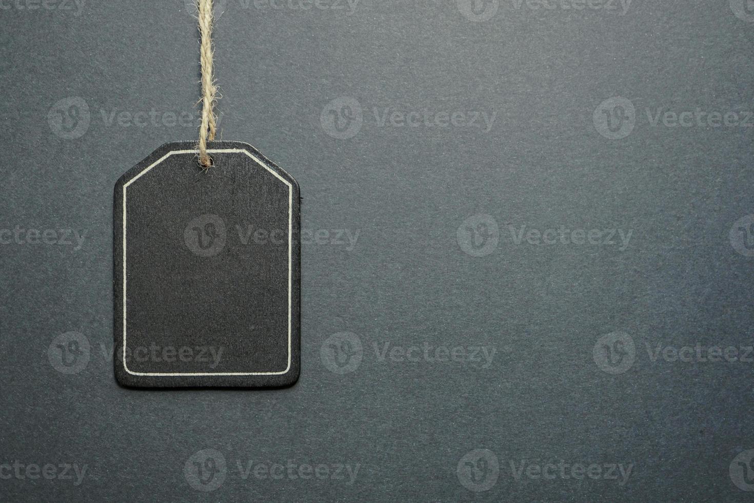 black price tag on the black background, black mockup photo