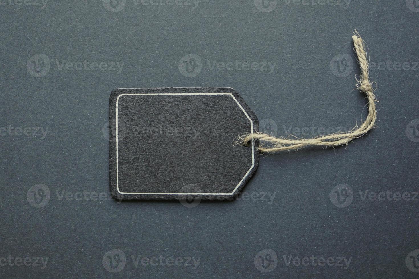 black price tag on the black background, black mockup photo