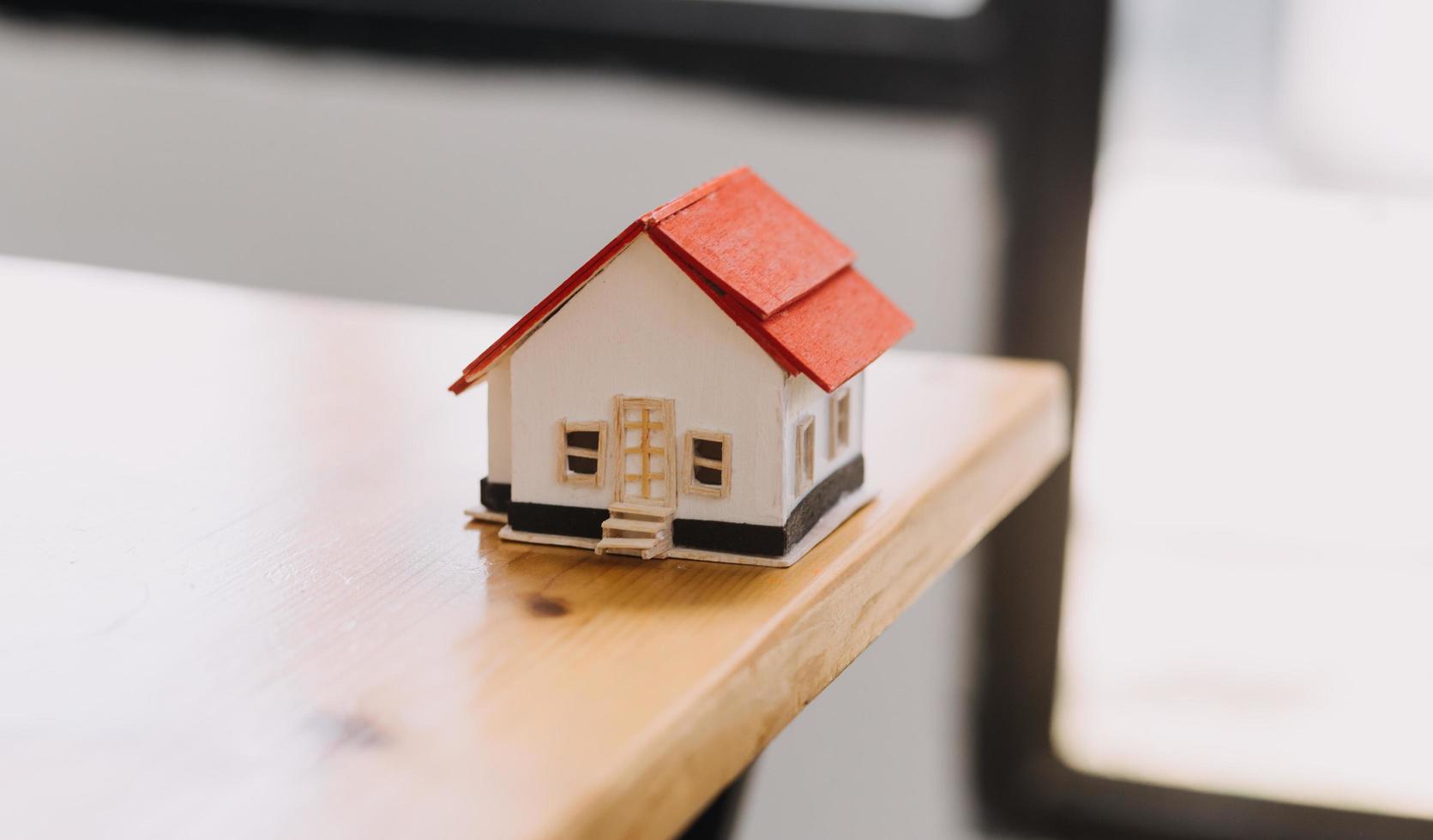 Discussion with a real estate agent, House model with agent and customer discussing for the contract to buy, get insurance or loan real estate or property. photo
