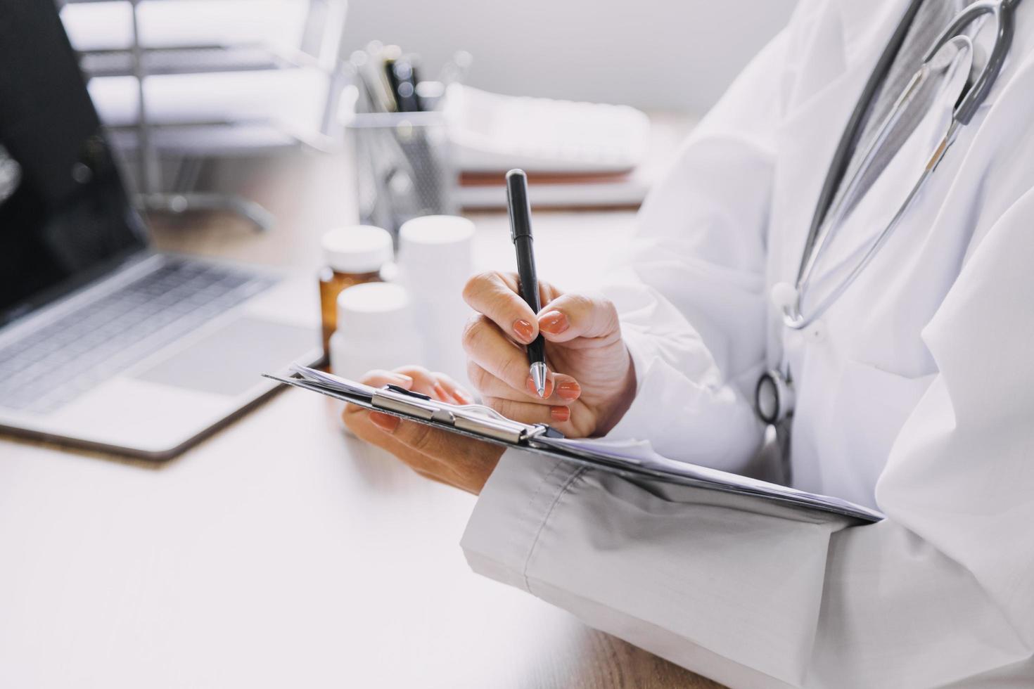 Homecare nursing service and elderly people cardiology healthcare. Close up of young hispanic female doctor nurse check mature caucasian man patient heartbeat using stethoscope during visit photo