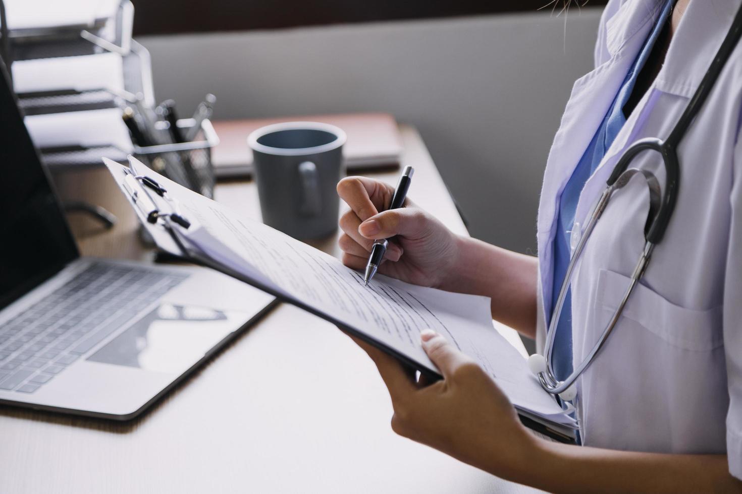 Homecare nursing service and elderly people cardiology healthcare. Close up of young hispanic female doctor nurse check mature caucasian man patient heartbeat using stethoscope during visit photo